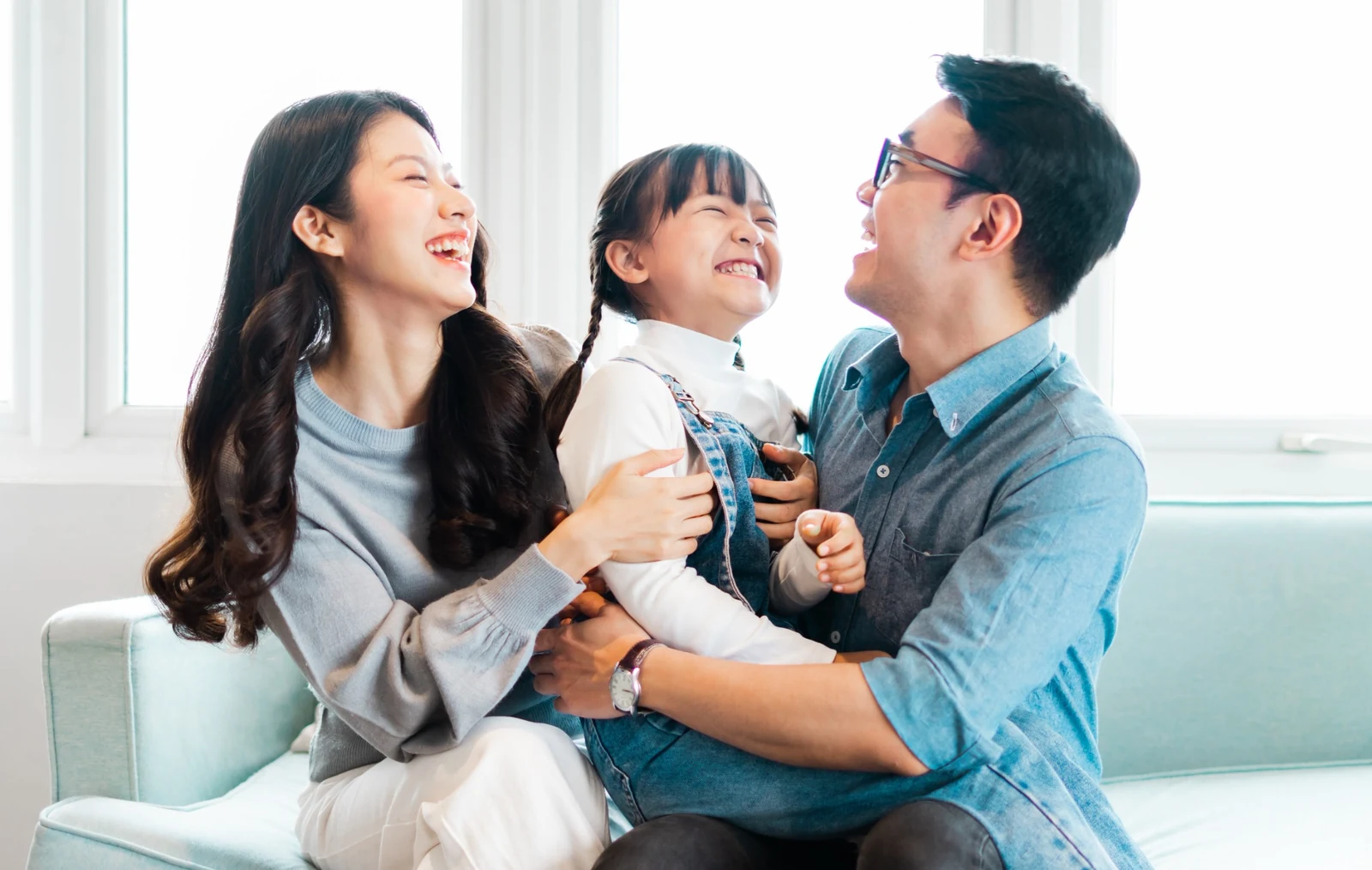 Asian parents supporting their child’s early smile development at home
