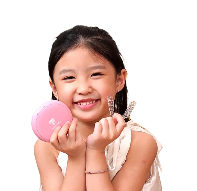 Smiling girl holding Dr Clear Aligners Junior clear aligners and case