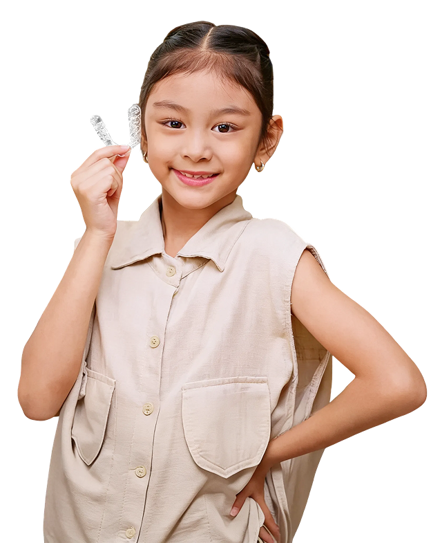 Child showing removable clear aligners designed for growing teeth